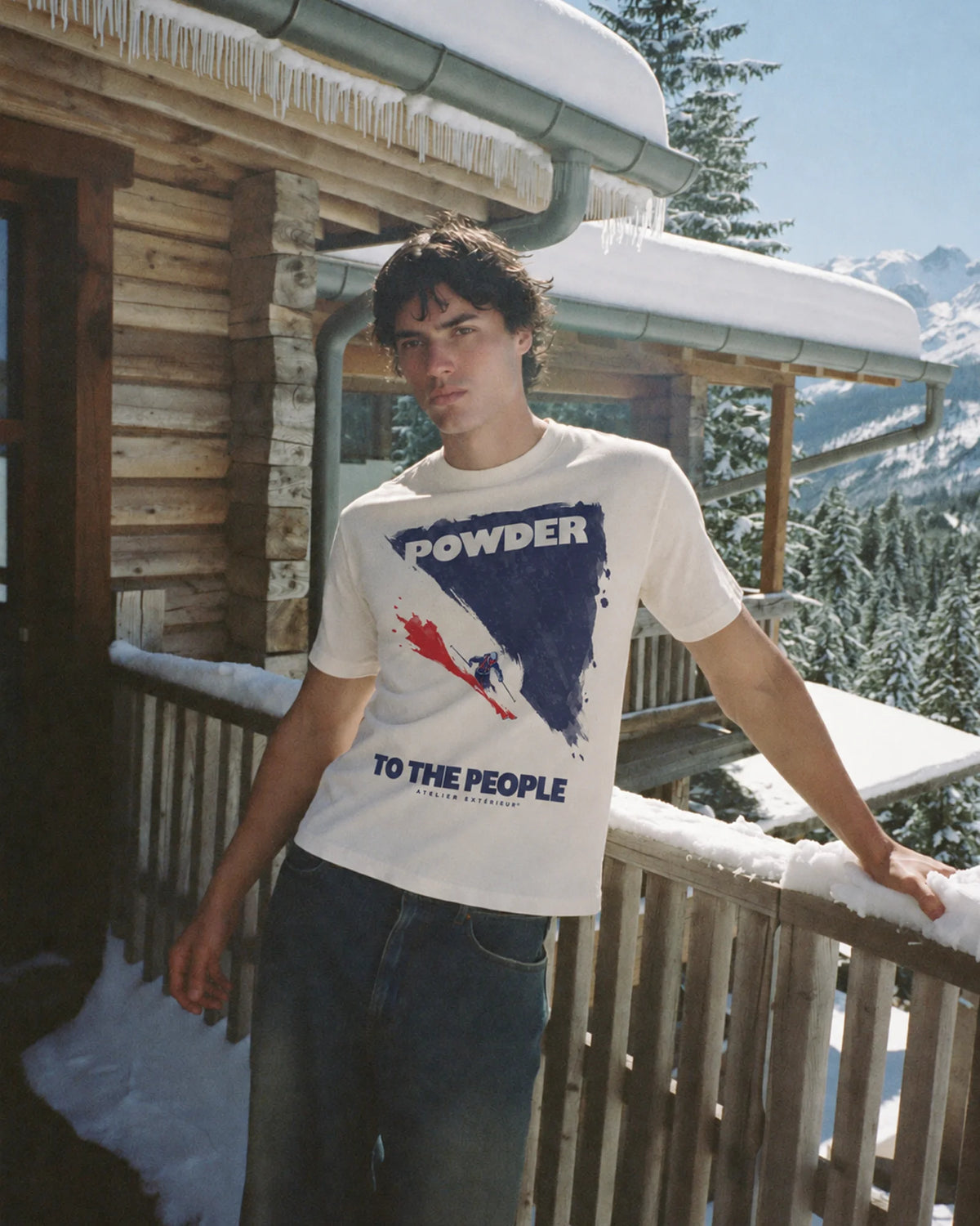 Man wearing the ecru Powder to the People tee outdoors, front view