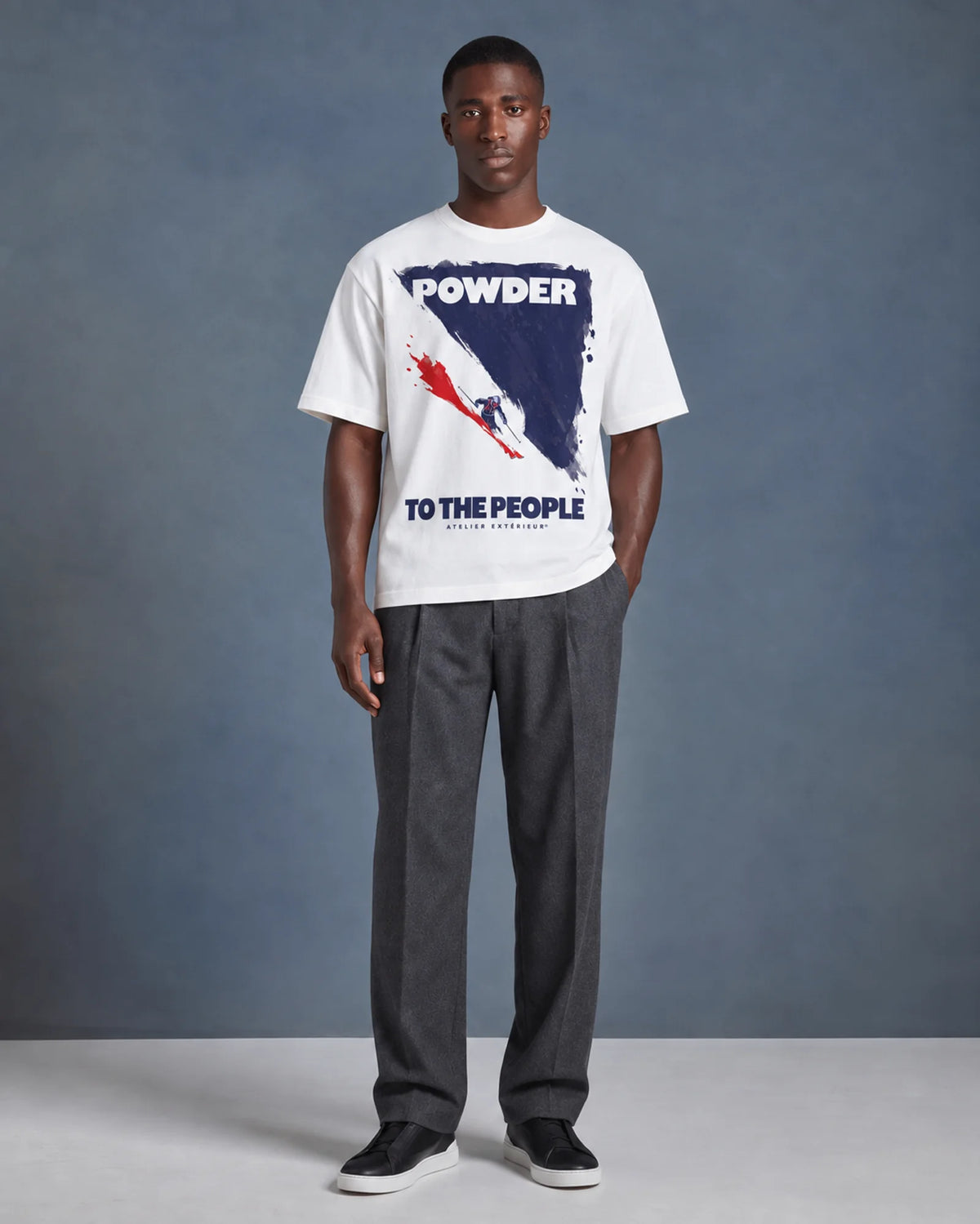 Model wearing the white Powder to the People tee in a studio, front view