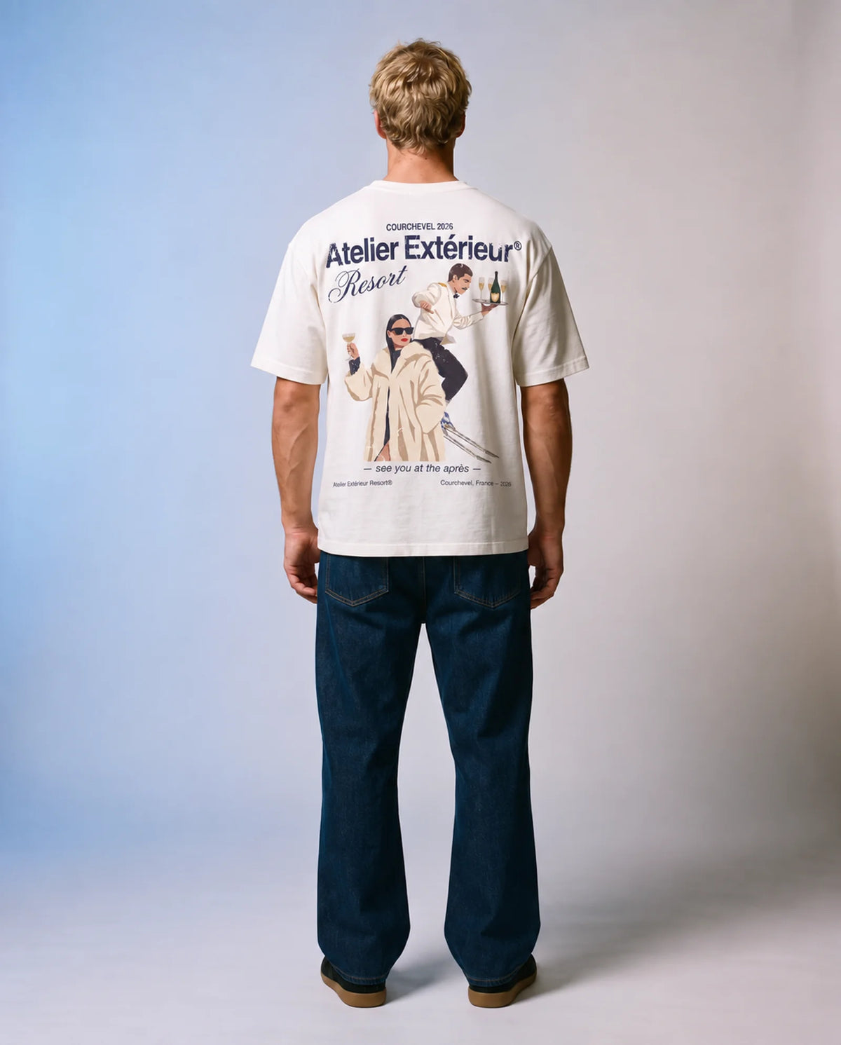 Model wearing the white Resort tee in a studio, back view