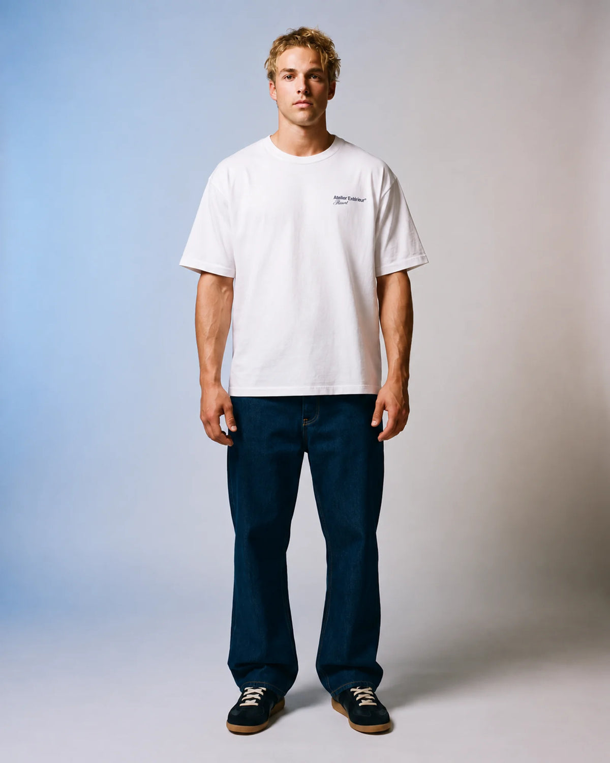 Model wearing the white Resort tee in a studio, front view