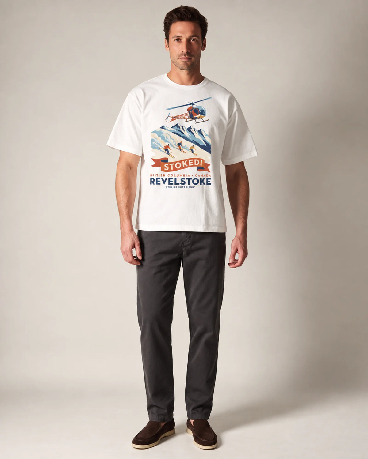 Model wearing the white Revelstoke tee in a studio, front view