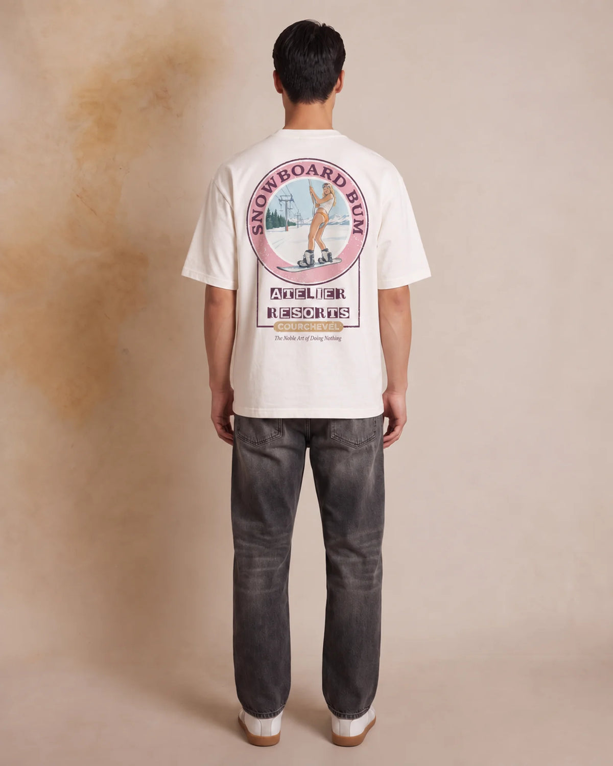Studio model wearing the white Snowboard Bum tee, back view