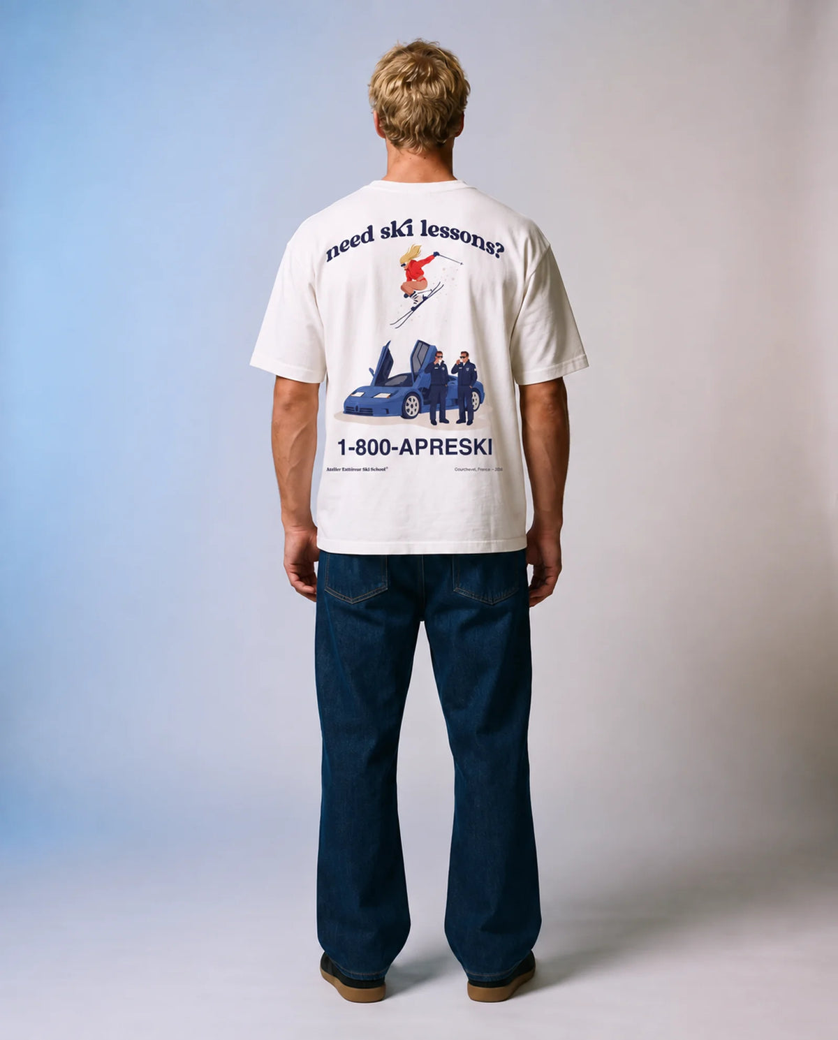 Studio model wearing the white Ski School tee, back view