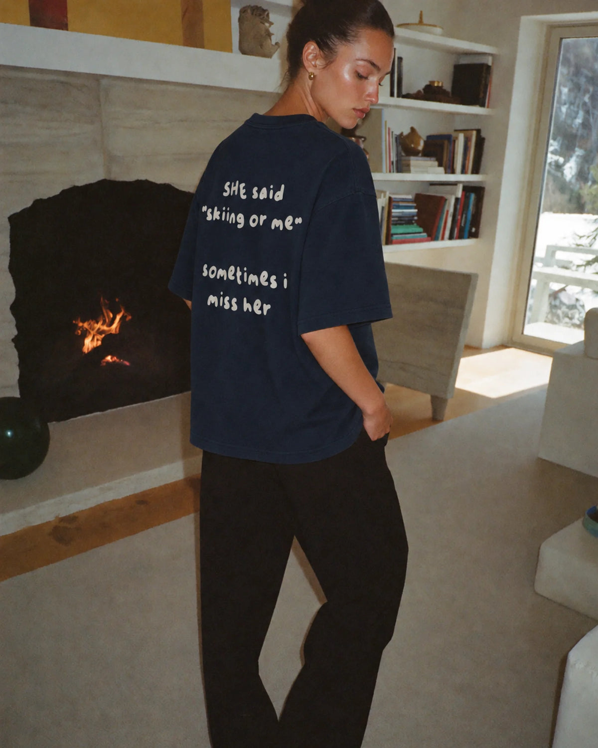 Woman wearing the Skiing or Me Tee in navy, on location