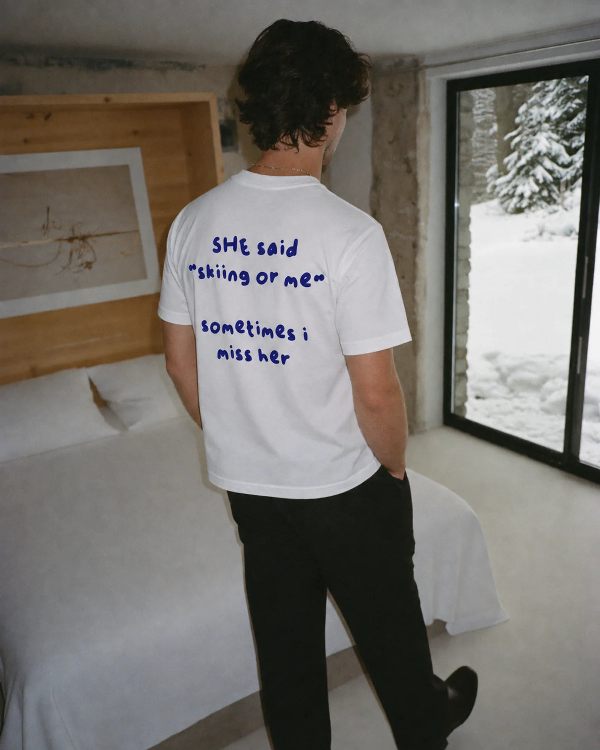 Man wearing the Skiing or Me Tee in white, on location