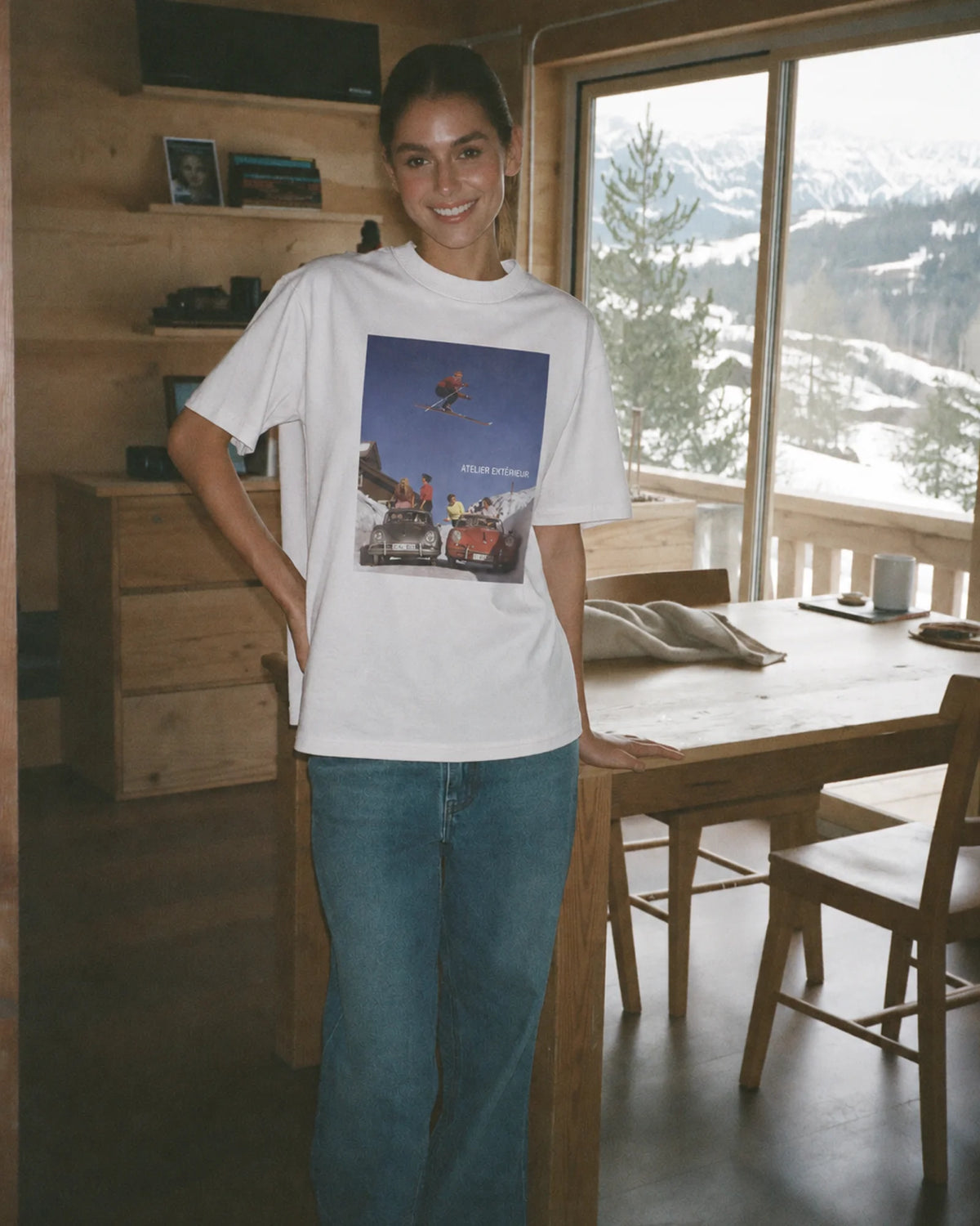 Woman wearing the white Ski Jump tee outdoors, front view