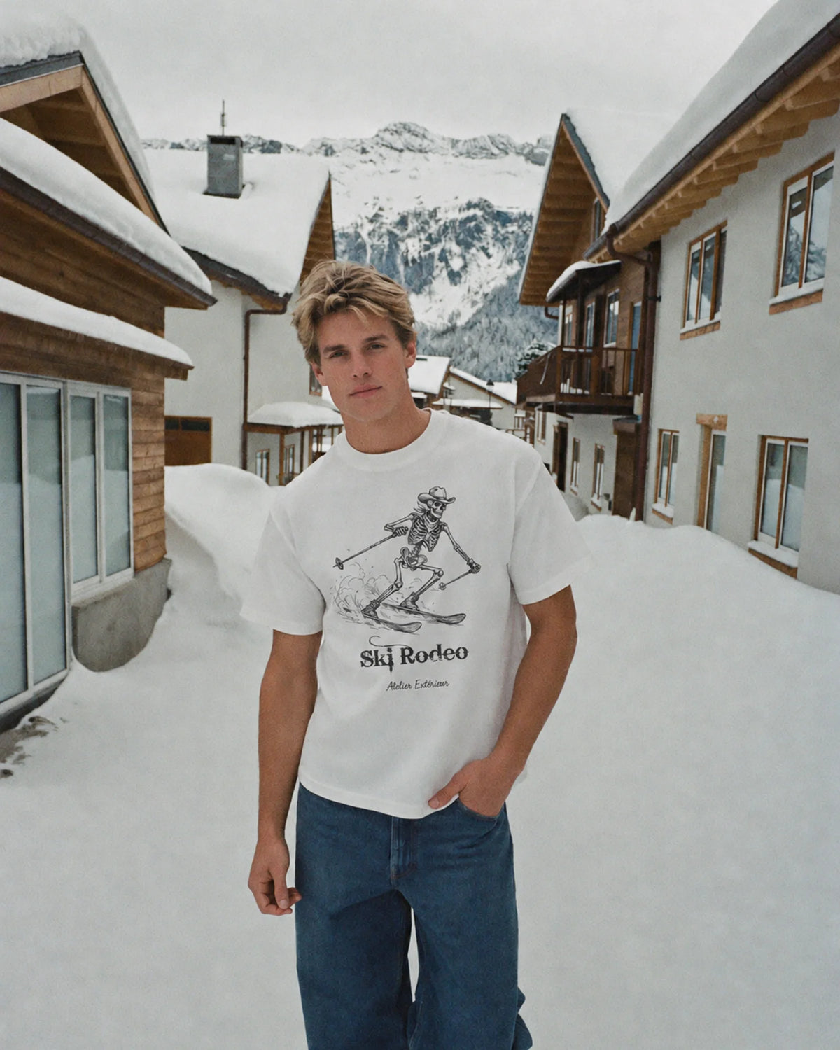 Man wearing the white Ski Rodeo tee outdoors, front view