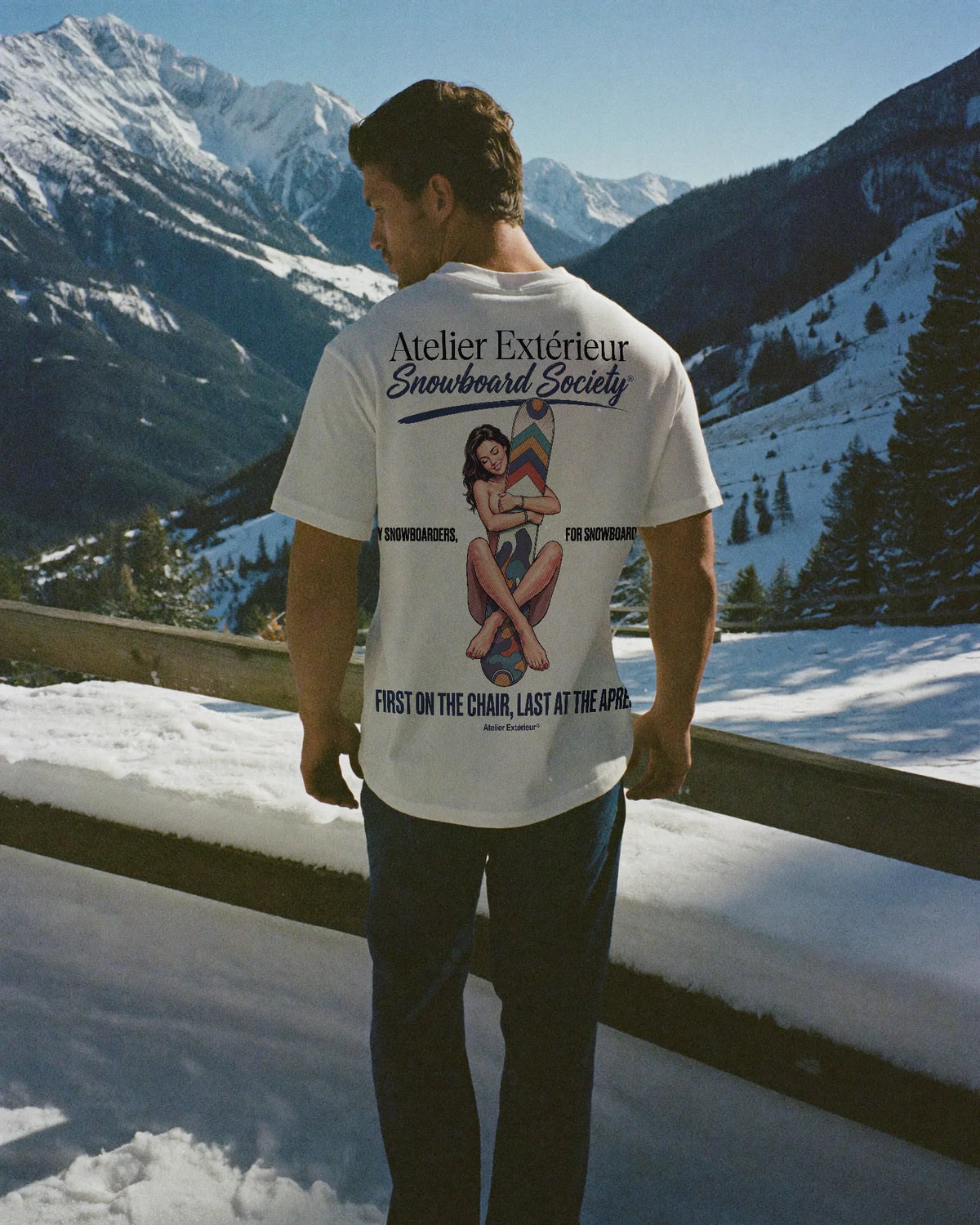 Man wearing the Snowboard Society Tee, on location