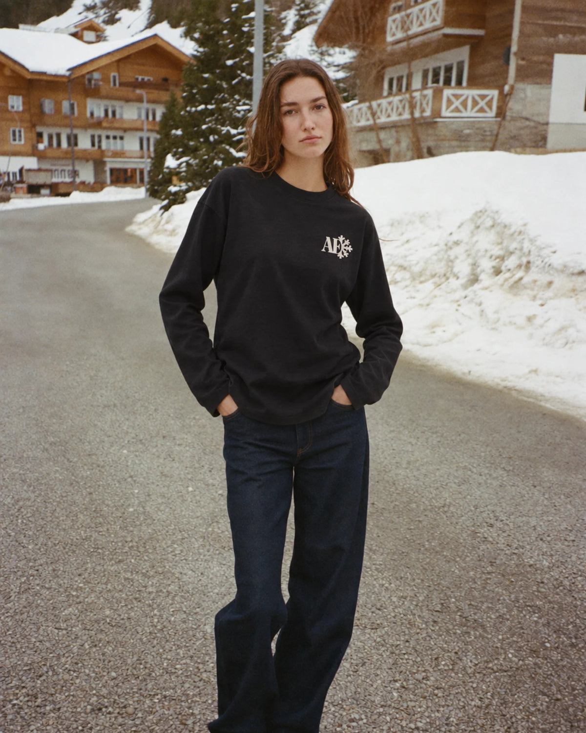 Woman wearing the Snowflake Long Sleeve Tee in black, on location