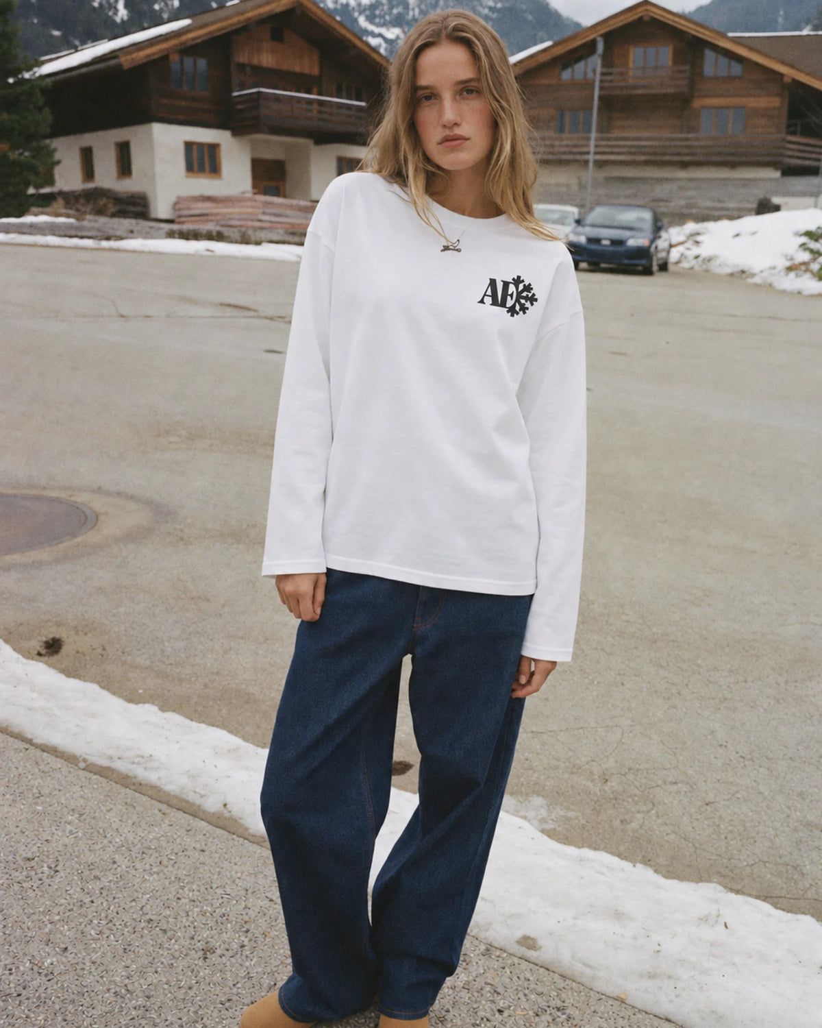 Woman wearing the Snowflake Long Sleeve Tee in white, on location