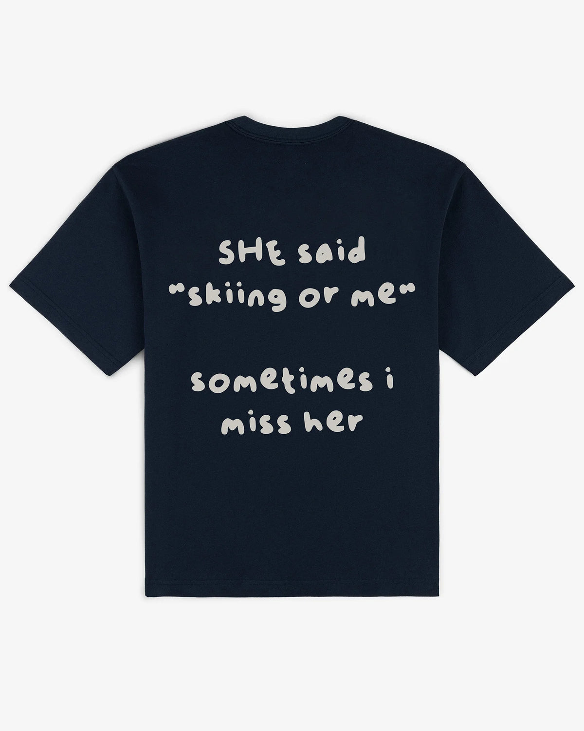 Skiing or Me tee in navy, flat lay back view with hand-drawn she said skiing or me graphic