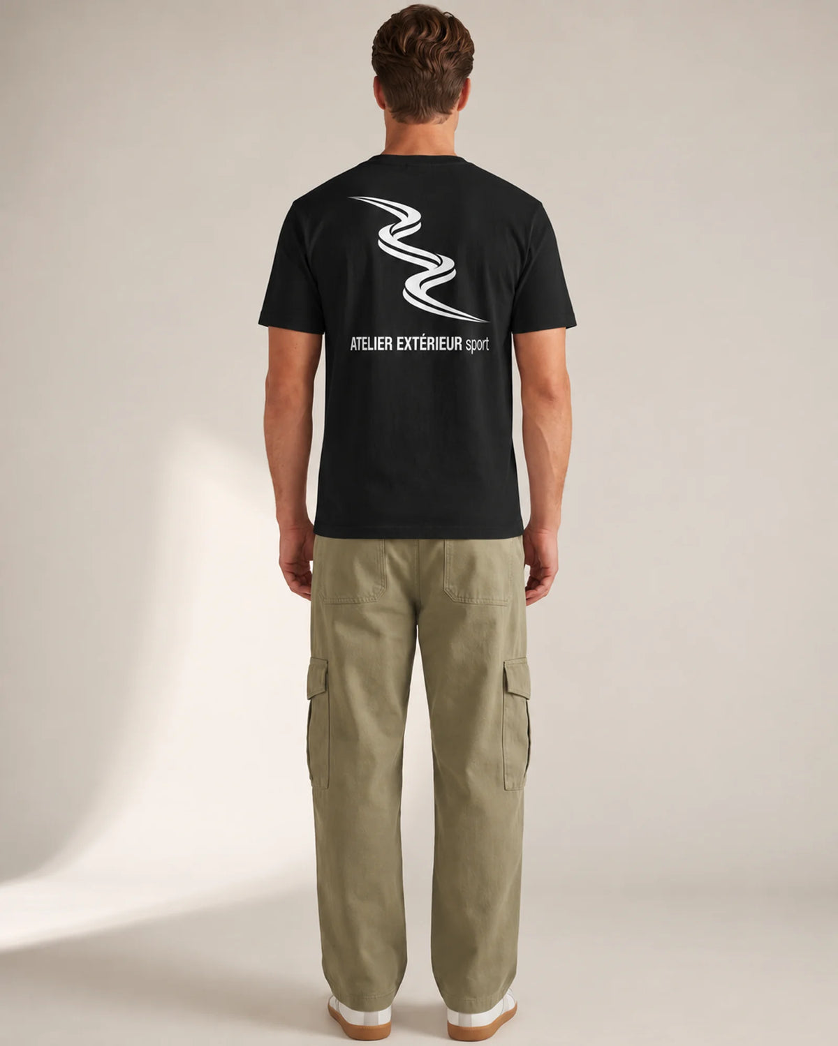 Studio model wearing the black Sport tee, back view