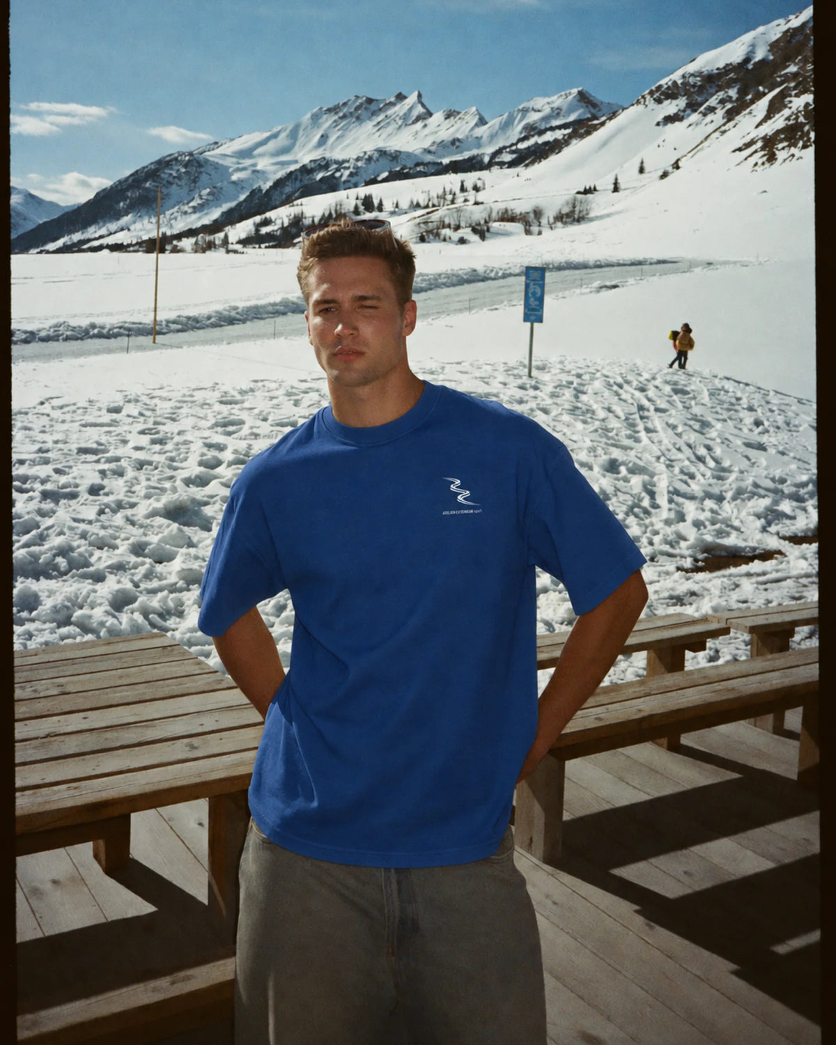 Man wearing the blue Sport tee in the snow