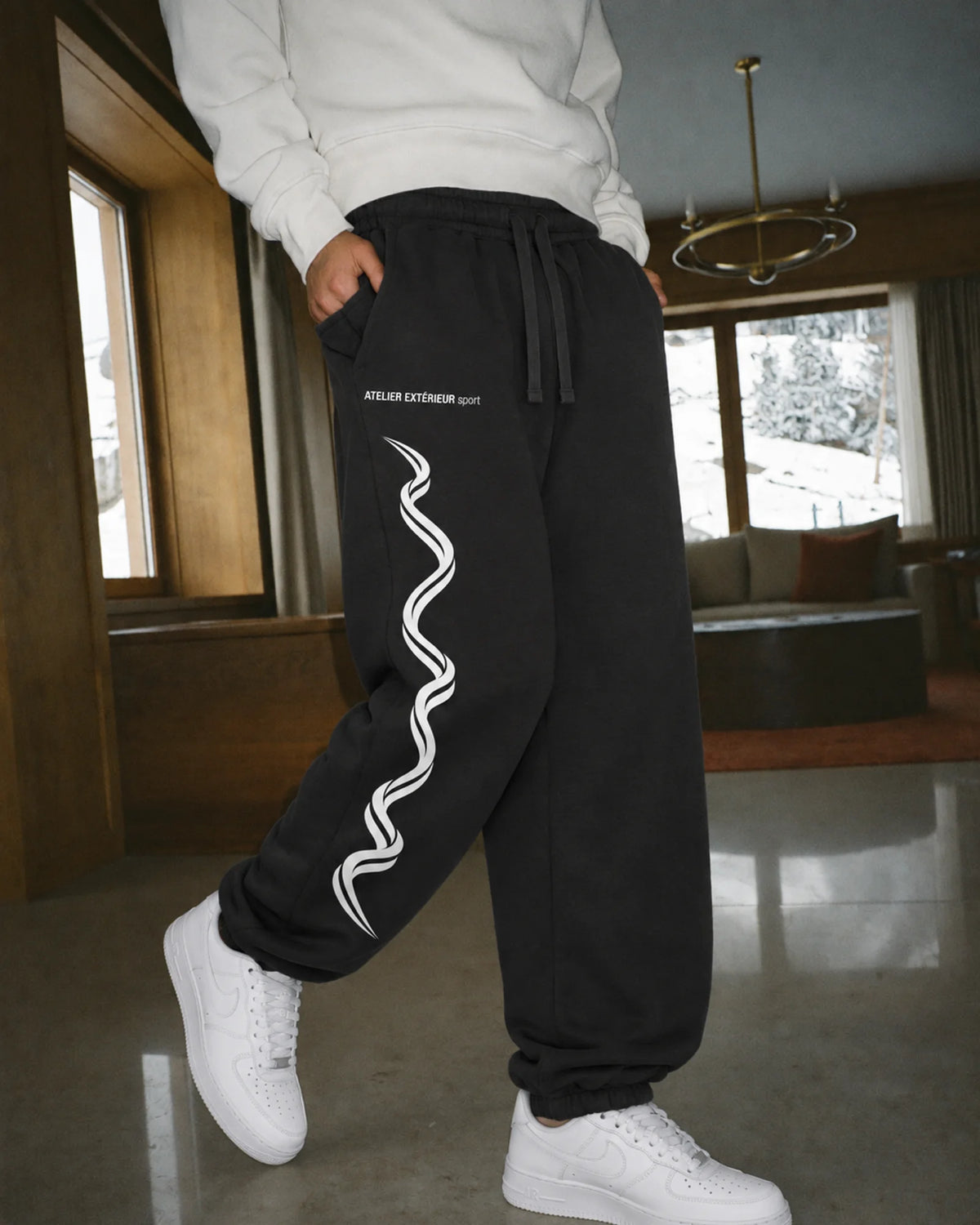 Model wearing the Sport Sweatpants - Cuffed in black, on location