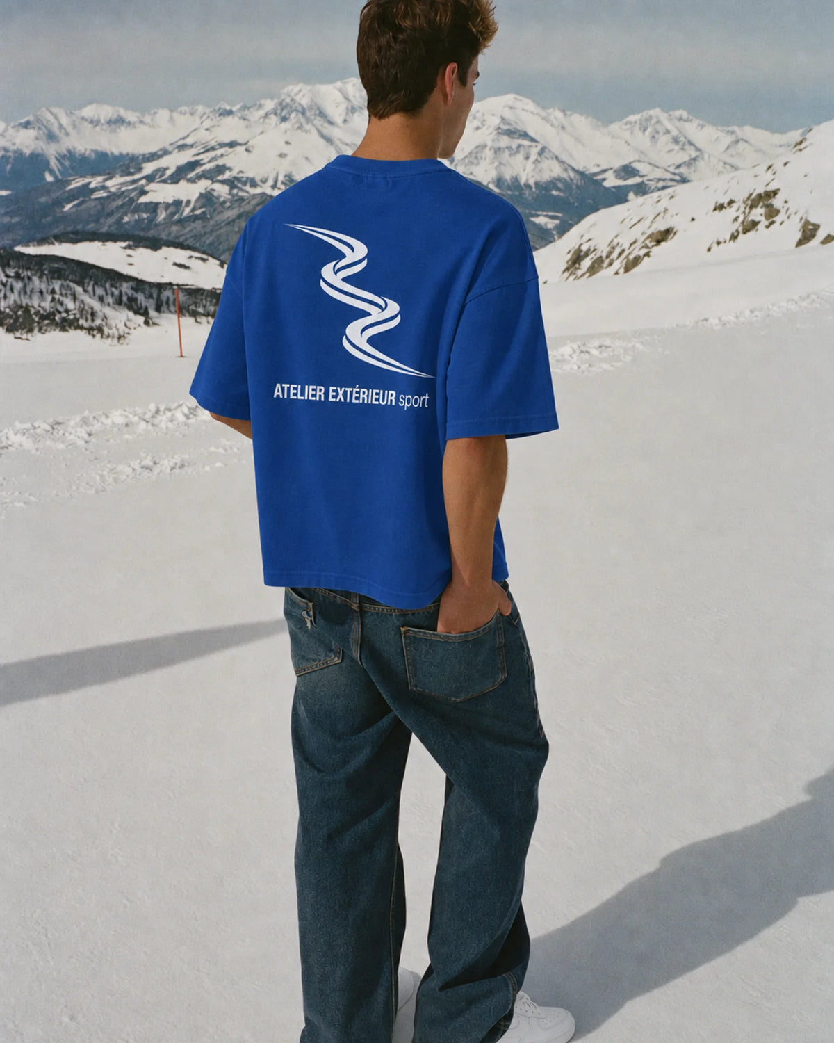Man wearing the Sport Tee in blue, on location