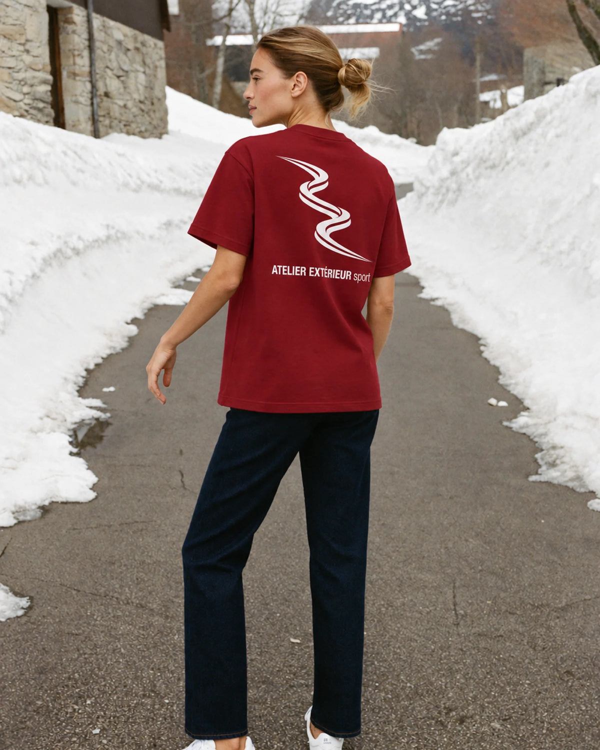 Woman wearing the Sport Tee in red, on location