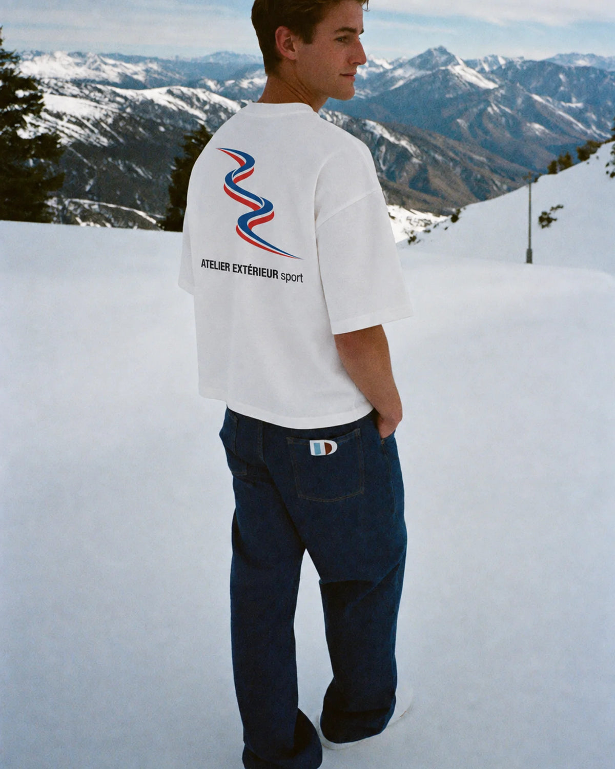 Man wearing the Sport Tee in white, on location