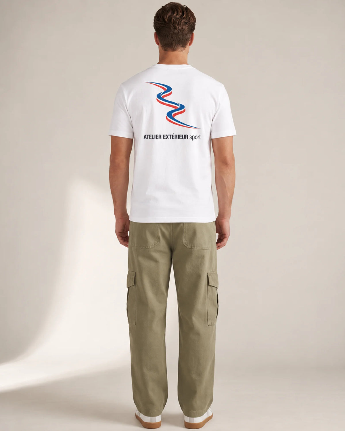 Studio model wearing the white Sport tee, back view