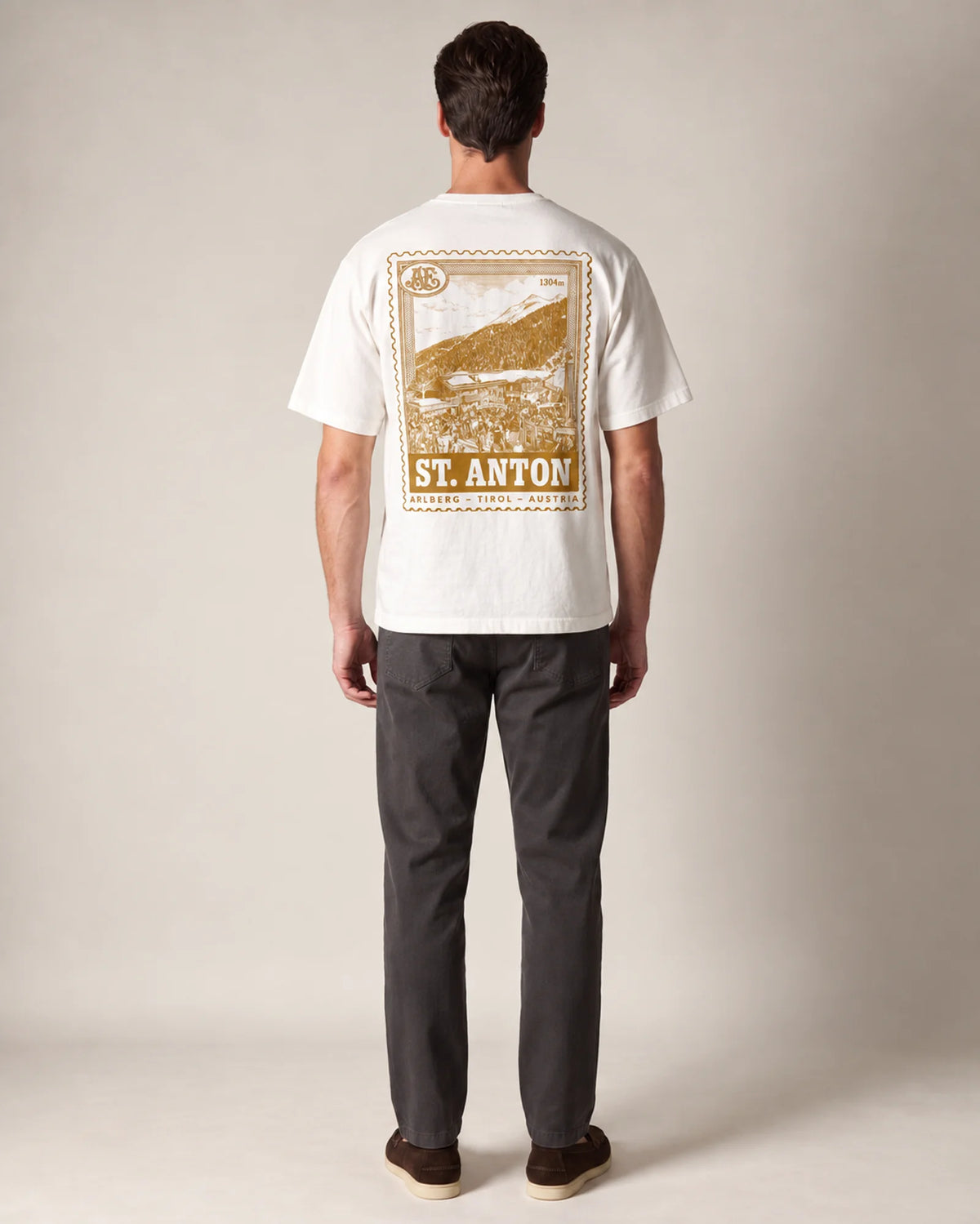 Studio model wearing the white St Anton tee, back view