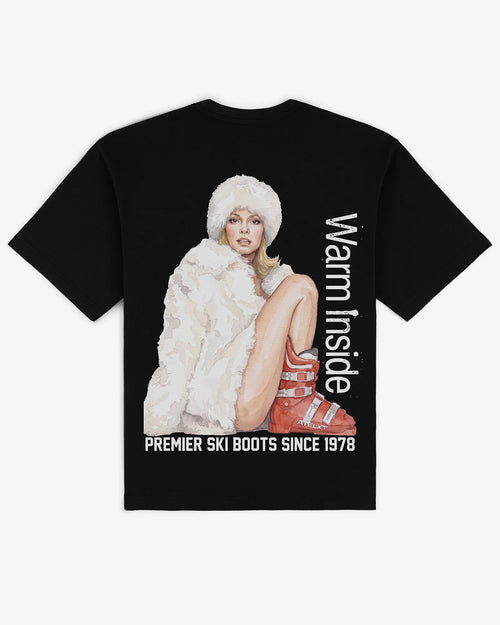 Warm Inside tee in black, flat lay back view with hand-painted ski boot graphic