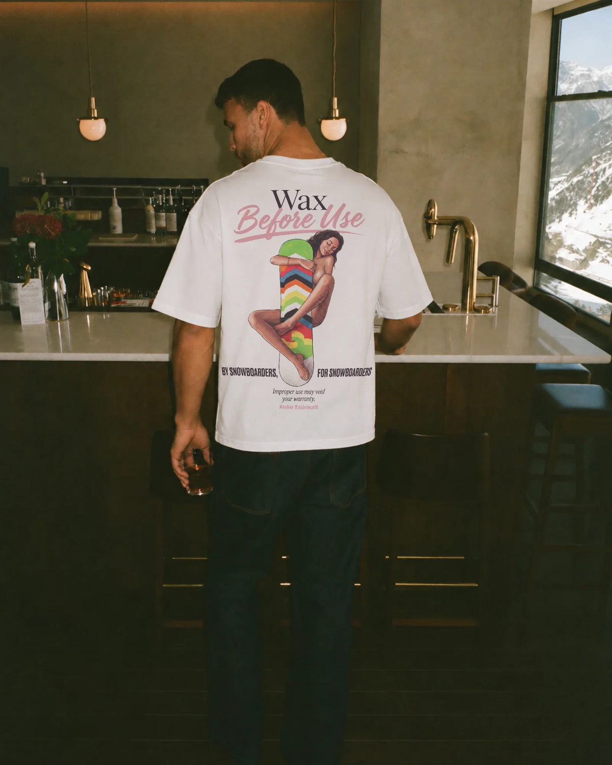 Man wearing the Wax Before Use Tee in white, on location
