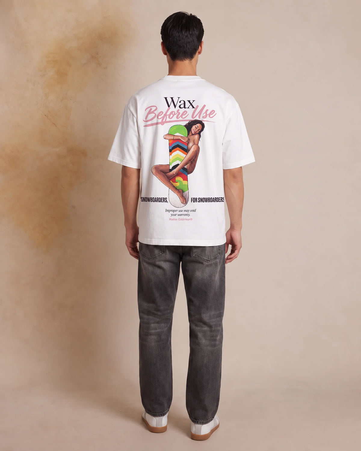 Studio model wearing the white Wax Before Use tee, back view