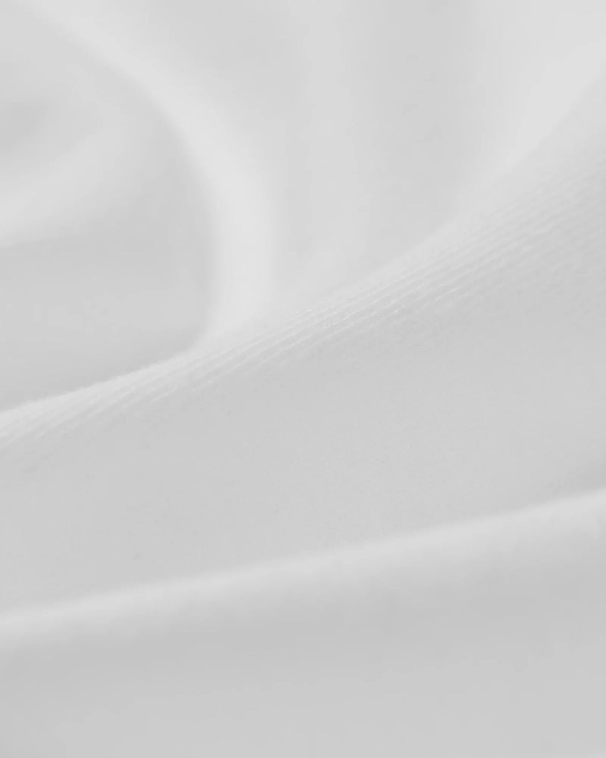 Close-up fabric detail of the white heavyweight cotton jersey